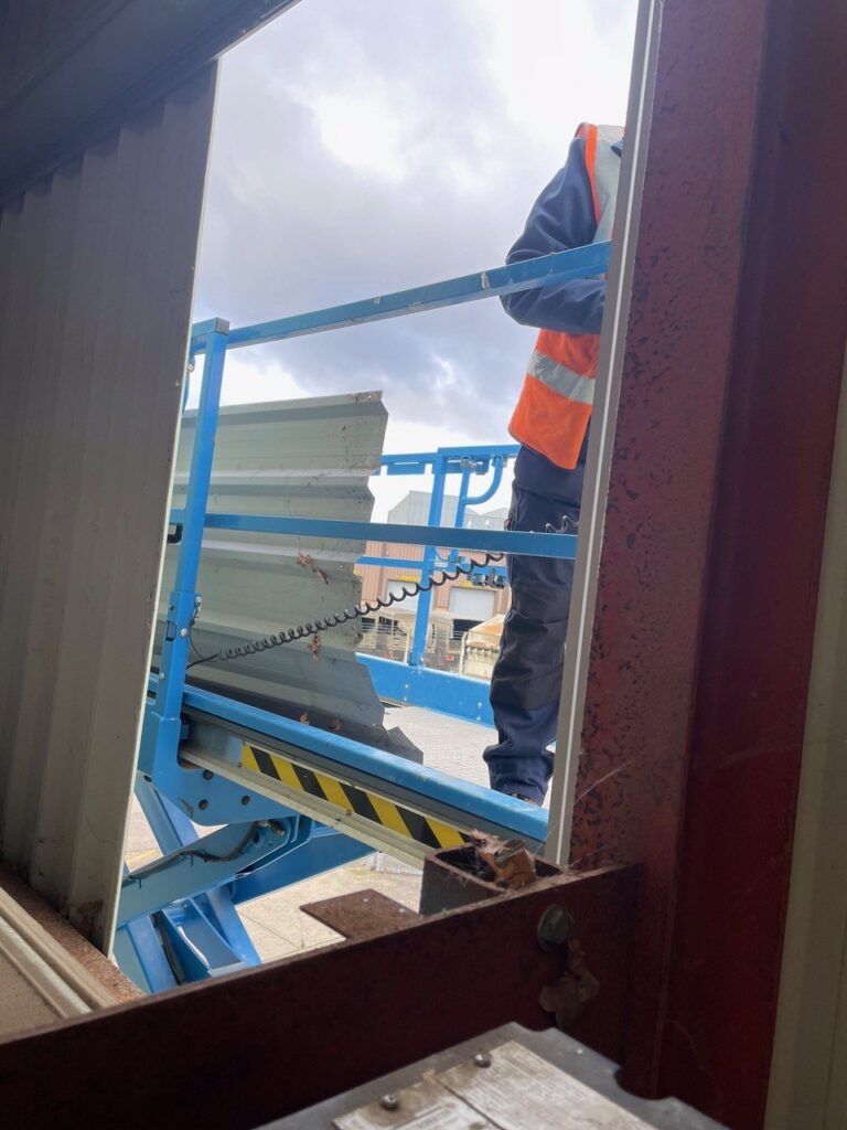 Work being carried out on a roller shutter door demonstrating the importance of maintenance.